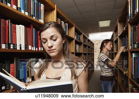 Two female students in library View Large Photo Image Stock Photo - Two female students in library. Fotosearch