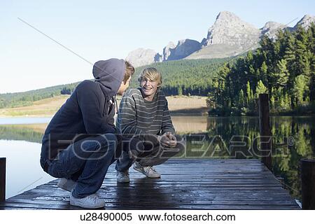 Two teenage boys on jetty, Cape Town, South Africa View Large Photo Image Stock Photography - Two teenage boys on jetty, Cape Town, South Africa. Fotosearch