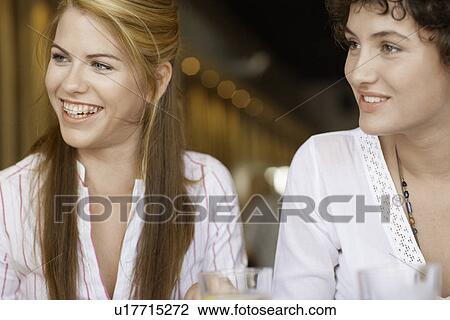 Two young women in cafe View Large Photo Image Stock Image - Two young women in cafe. Fotosearch