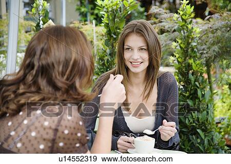 Two women drinking coffee View Large Photo Image Stock Photo - Two women drinking coffee. Fotosearch