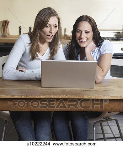 Two Women Using Laptop View Large Photo Image Picture - Two Women Using Laptop. Fotosearch