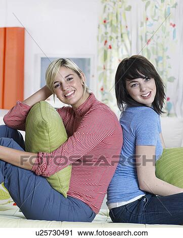 Two Young Women Sitting Back to Back View Large Photo Image Stock Image - Two Young Women Sitting Back to Back. Fotosearch