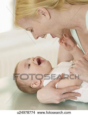Picture - Mother and Baby Boy Looking at Each Other. Fotosearch