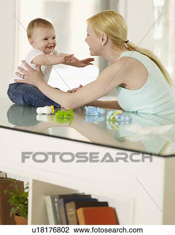 Stock Image - Mother and Baby Boy Looking at Each Other. Fotosearch