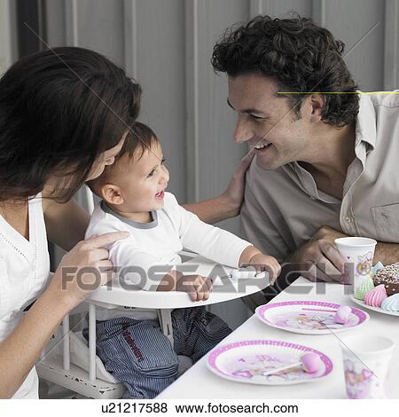 Stock Photo - Parents celebrating baby boy's (1-2) birthday. Fotosearch