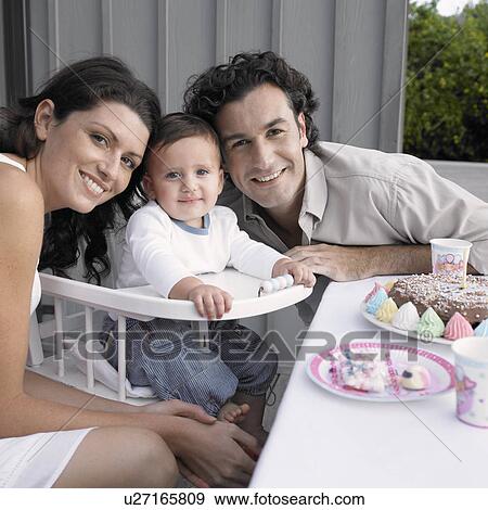 Parents celebrating baby boy's (1-2) birthday (portrait) View Large Photo Image Stock Photo - Parents celebrating baby boy's (1-2) birthday (portrait). Fotosearch