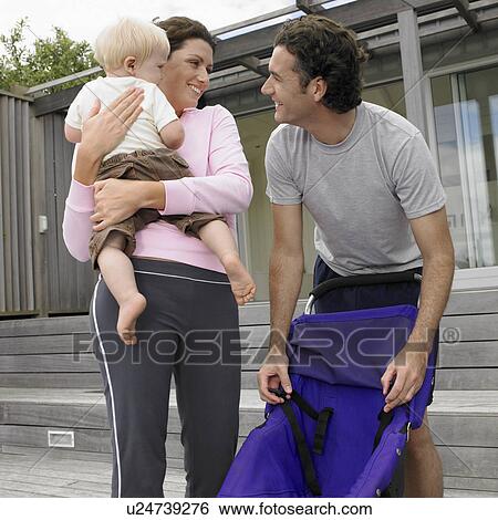Parents with baby boy (0-6 months) and pram View Large Photo Image Stock Photograph - Parents with baby boy (0-6 months) and pram. Fotosearch