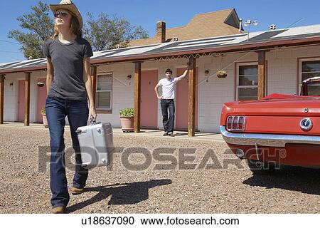 Girlfriend leaving motel, boyfriend looking in background View Large Photo Image Stock Image - Girlfriend leaving motel, boyfriend looking in background. Fotosearch