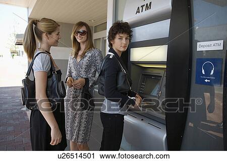 Teenage girls at cash machine View Large Photo Image Stock Image - Teenage girls at cash machine. Fotosearch