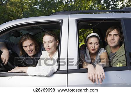 Stock Photo - Two young couples in car (portrait). Fotosearch