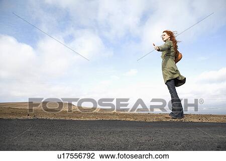 Woman hitchhiking (low angle view) View Large Photo Image Stock Image - Woman hitchhiking (low angle view). Fotosearch