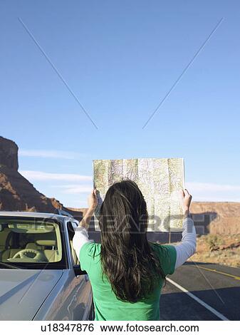 Woman reading map by car, rear view, Moab, Utah, USA View Large Photo Image Stock Photograph - Woman reading map by car, rear view, Moab, Utah, USA. Fotosearch