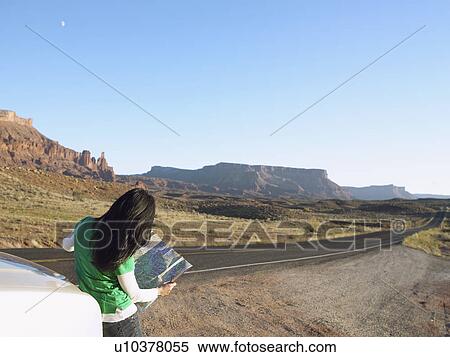 Woman reading map in desert, rear view, Moab, Utah, USA View Large Photo Image Stock Photography - Woman reading map in desert, rear view, Moab, Utah, USA. Fotosearch