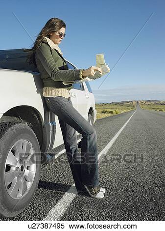 Woman reading road map by car on highway View Large Photo Image Stock Photography - Woman reading road map by car on highway. Fotosearch