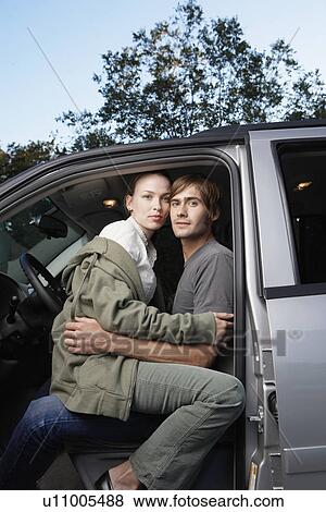 Woman sitting on man's lap in car (portrait) View Large Photo Image Stock Photo - Woman sitting on man's lap in car (portrait). Fotosearch