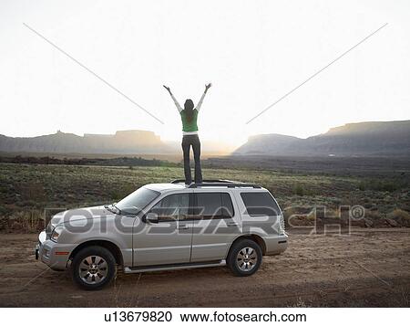 Woman standing on roof of car, arms outstretched, rear view, Moab, Utah, USA View Large Photo Image Stock Image - Woman standing on roof of car, arms outstretched, rear view, Moab, Utah, USA. Fotosearch