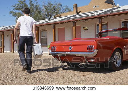 Young man arriving at motel, Arizona, USA View Large Photo Image Stock Photo - Young man arriving at motel, Arizona, USA. Fotosearch