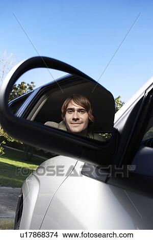 Young Man Driving Car, Reflection in Side Mirror View Large Photo Image Picture - Young Man Driving Car, Reflection in Side Mirror. Fotosearch