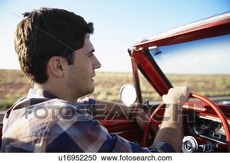 Young man driving convertible View Large Photo Image Stock Image - Young man driving convertible. Fotosearch