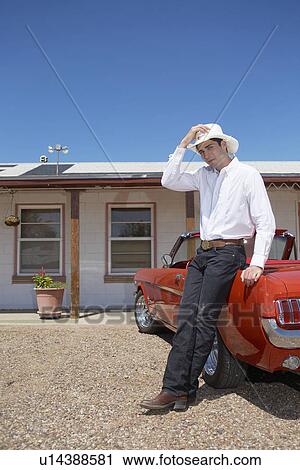 Young man in Western style attire leaning on convertible View Large Photo Image Stock Image - Young man in Western style attire leaning on convertible. Fotosearch