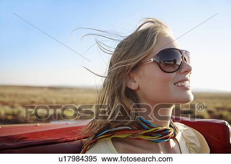 Stock Photography - Young woman in convertible. Fotosearch