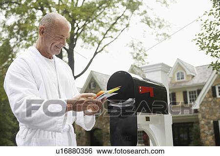 Stock Photograph - Mature man going through mail, Chatham, New Jersey, USA. Fotosearch