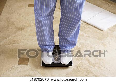 Mature man on bathroom scale (low section) View Large Photo Image Stock Image - Mature man on bathroom scale (low section). Fotosearch