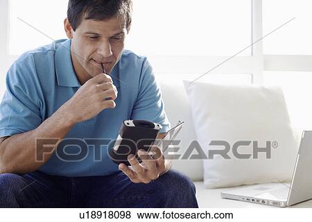 Mature man using PDA View Large Photo Image Stock Photo - Mature man using PDA. Fotosearch
