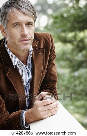 Mid adult man leaning on railing (portrait) View Large Photo Image Stock Photography - Mid adult man leaning on railing (portrait). Fotosearch