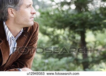 Mid adult man looking at view View Large Photo Image Stock Image - Mid adult man looking at view. Fotosearch