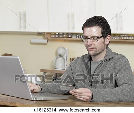 Mid-Adult Man Shopping Online View Large Photo Image Picture - Mid-Adult Man Shopping Online. Fotosearch