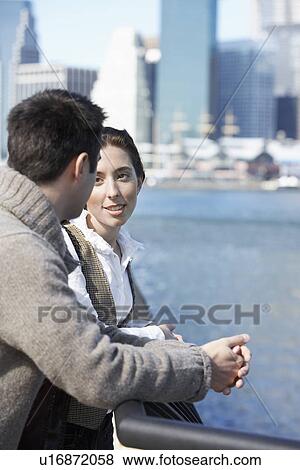 Stock Photo - Couple talking by railings. Fotosearch