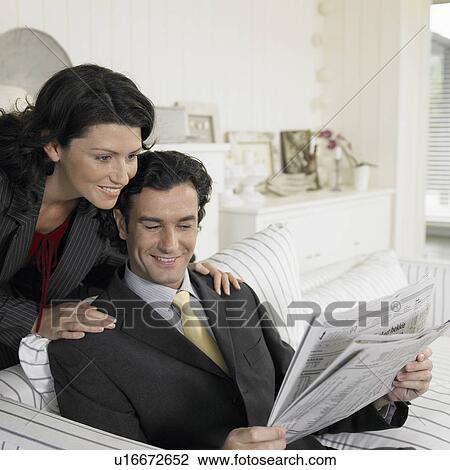 Mid adult couple reading newspaper View Large Photo Image Stock Image - Mid adult couple reading newspaper. Fotosearch