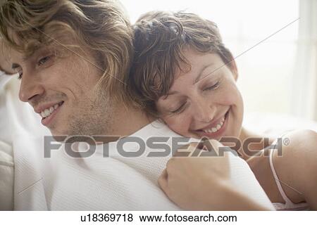 Woman hugging man from behind View Large Photo Image Stock Photo - Woman hugging man from behind. Fotosearch