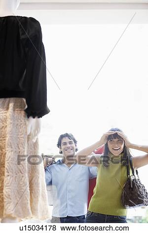 Woman window shopping, boyfriend in background View Large Photo Image Stock Photo - Woman window shopping, boyfriend in background. Fotosearch