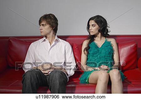 Young couple arguing on sofa View Large Photo Image Stock Photograph - Young couple arguing on sofa. Fotosearch