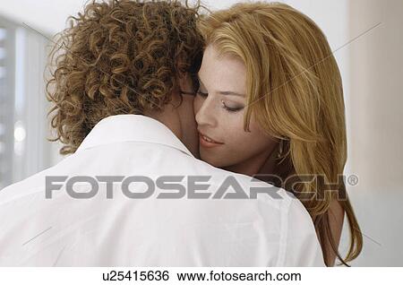 Young couple embracing View Large Photo Image Stock Photograph - Young couple embracing. Fotosearch