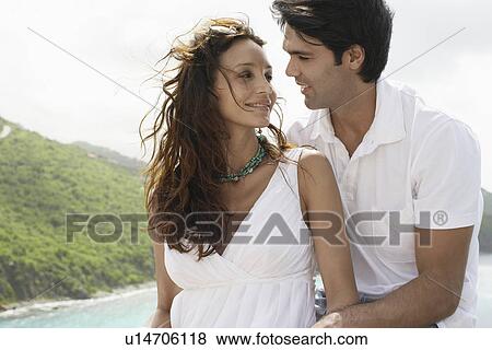 Young couple hugging at seaside View Large Photo Image Stock Photo - Young couple hugging at seaside. Fotosearch