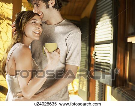Young couple hugging in patio View Large Photo Image Stock Photography - Young couple hugging in patio. Fotosearch