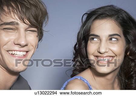 Picture - Young couple laughing (portrait). Fotosearch
