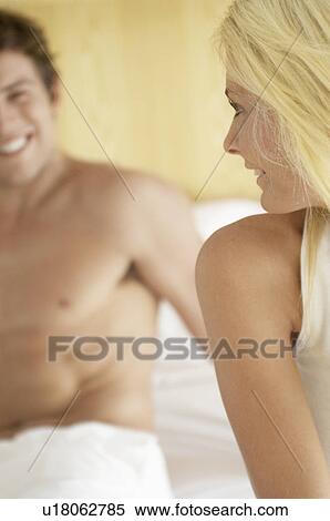 Young couple on bed View Large Photo Image Stock Photography - Young couple on bed. Fotosearch