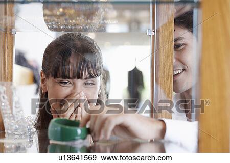 Stock Photo - Young couple shopping jewelry. Fotosearch