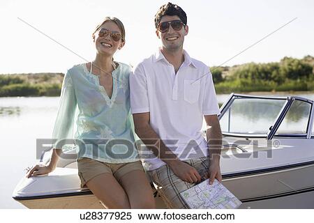 Young couple leaning on motorboat View Large Photo Image Stock Photography - Young couple leaning on motorboat. Fotosearch