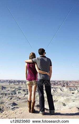Stock Image - Young couple looking at rocky landscape, Arizona, USA. Fotosearch