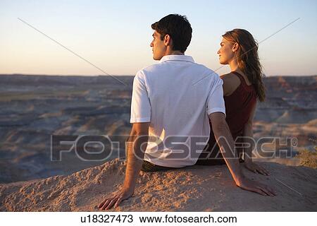 Young couple looking at view on cliff, Arizona, USA View Large Photo Image Stock Image - Young couple looking at view on cliff, Arizona, USA. Fotosearch
