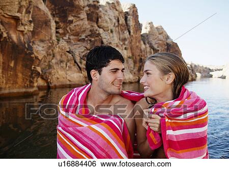 Young couple wrapped in a towel and looking at each other View Large Photo Image Stock Photograph - Young couple wrapped in a towel and looking at each other. Fotosearch