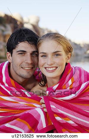 Stock Photography - Young couple wrapped in a towel. Fotosearch