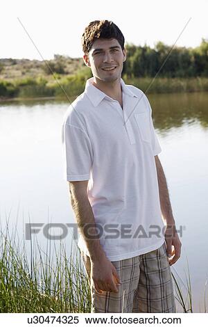 Young man by lake View Large Photo Image Stock Photography - Young man by lake. Fotosearch