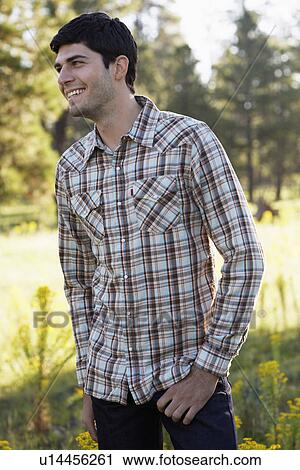 Stock Image - Young man in checked shirt. Fotosearch