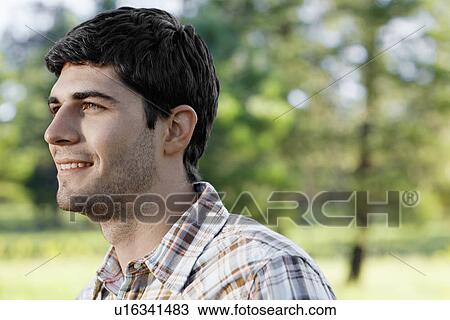 Young man in checked shirt View Large Photo Image Stock Image - Young man in checked shirt. Fotosearch